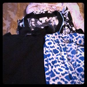 Various shirts and tops in medium and small sizes.